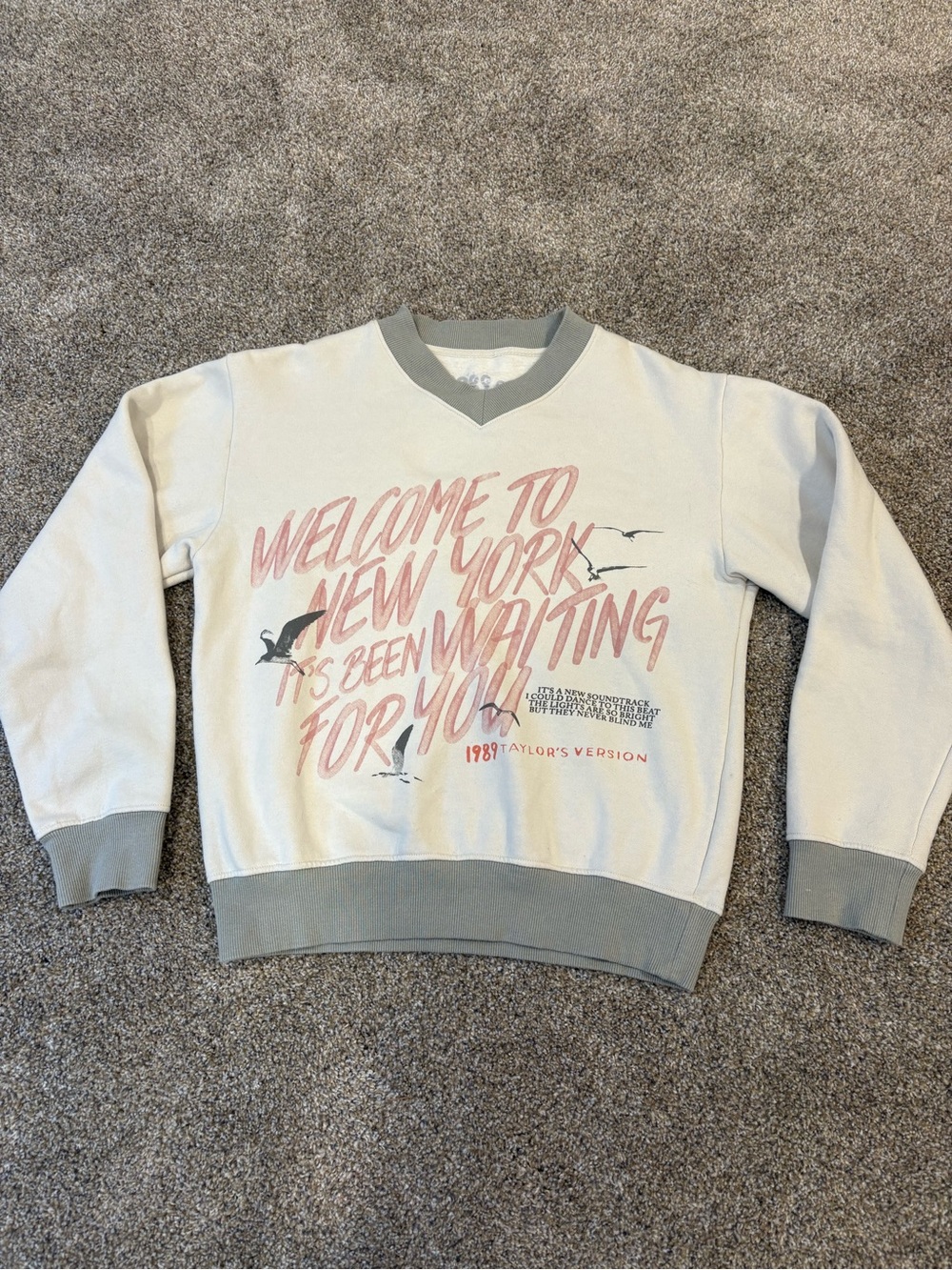 1989 Taylor Swift Cream V-Neck Graphic Sweater with Pink Script and Gray Trim